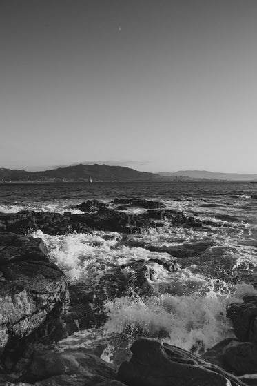 black and white waves on rocks