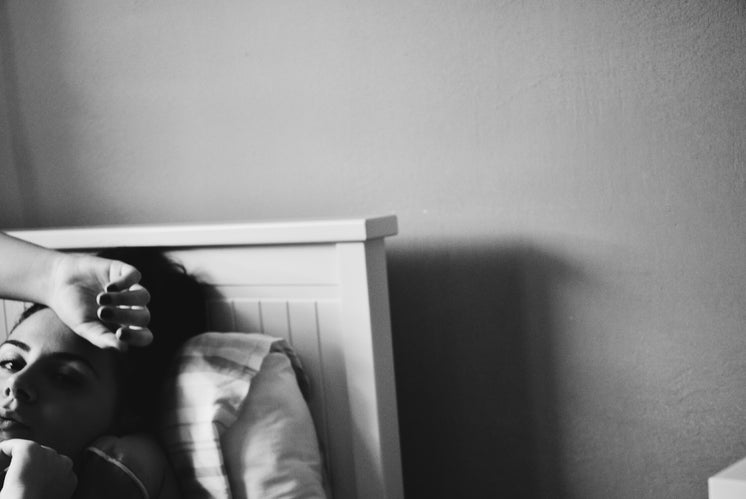 Black And White Image Of A Woman In Bed