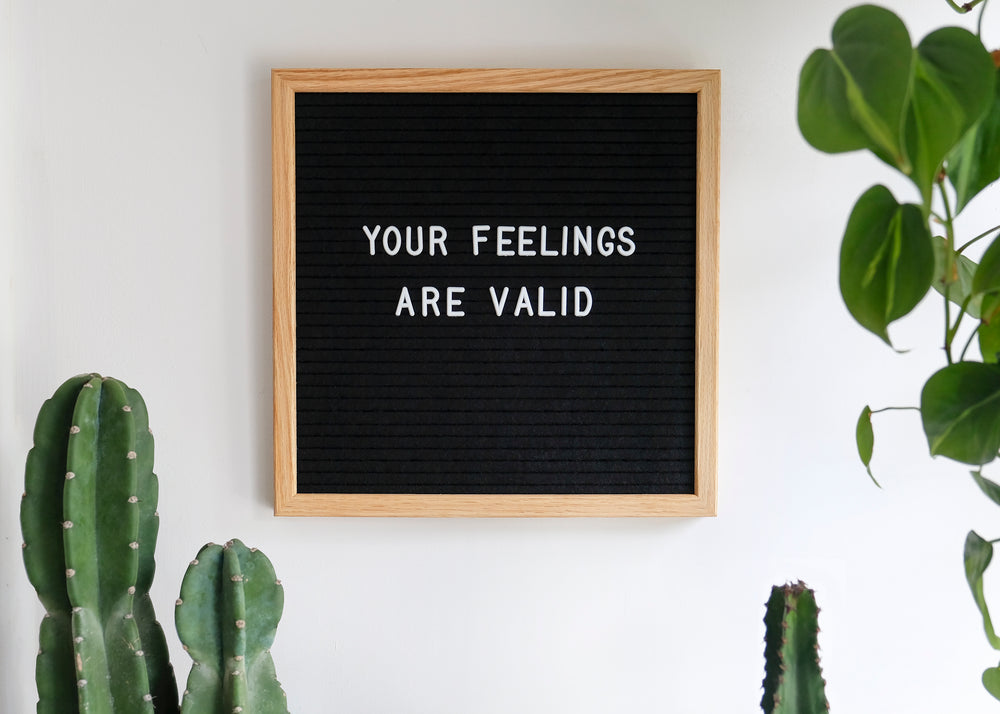 black board with white letters your feelings are valid