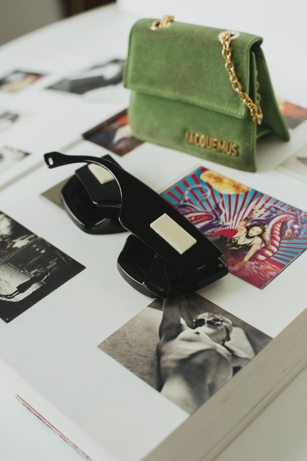 black bold sunglasses on a large book with photos
