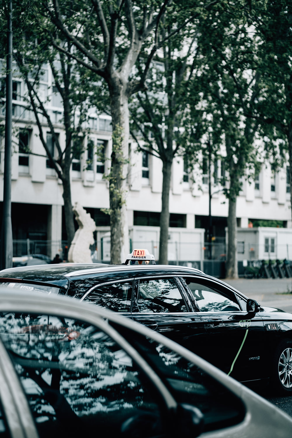 black car with a taxi sign on its roof