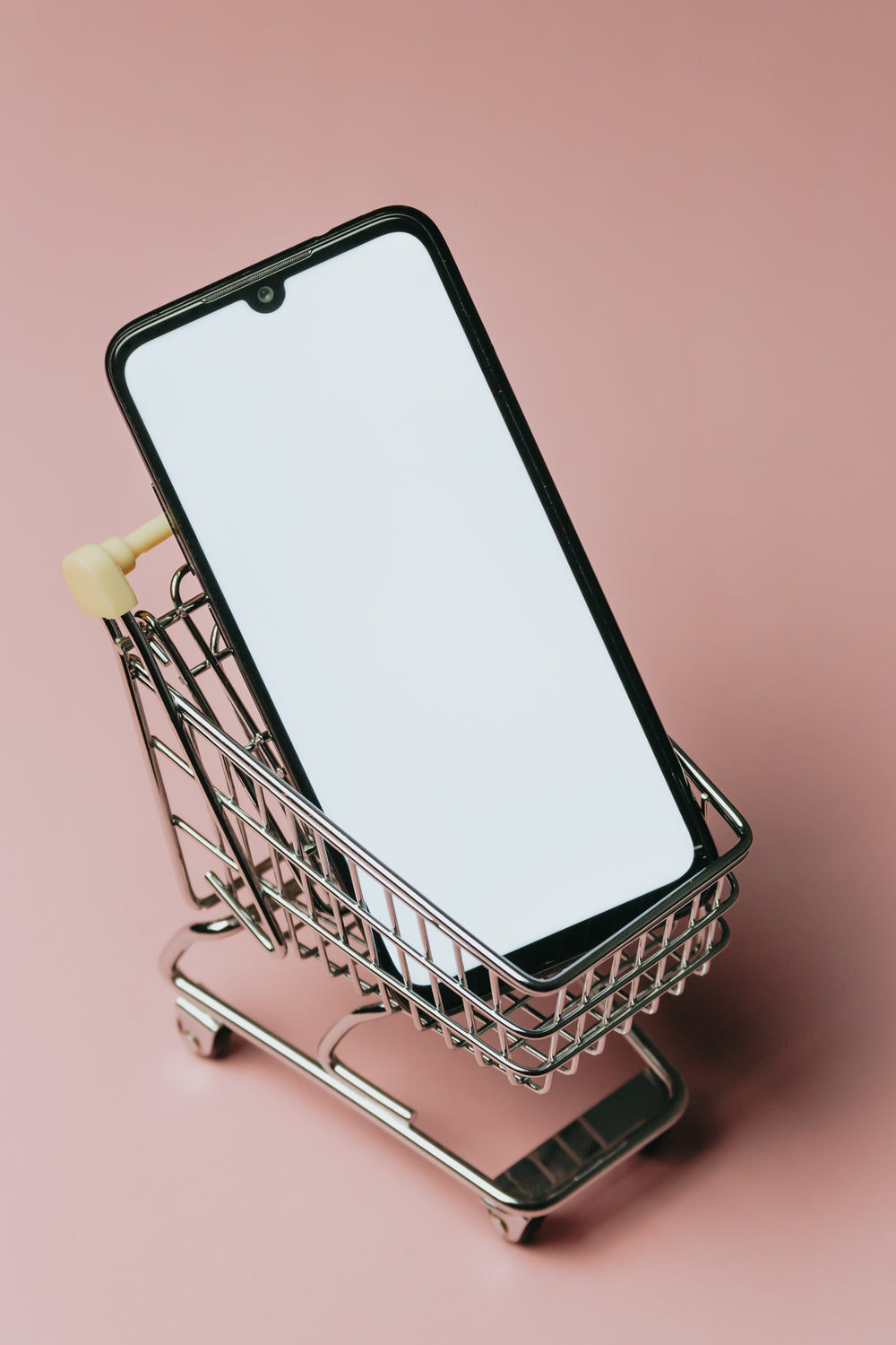 black cell phone in a small silver shopping cart