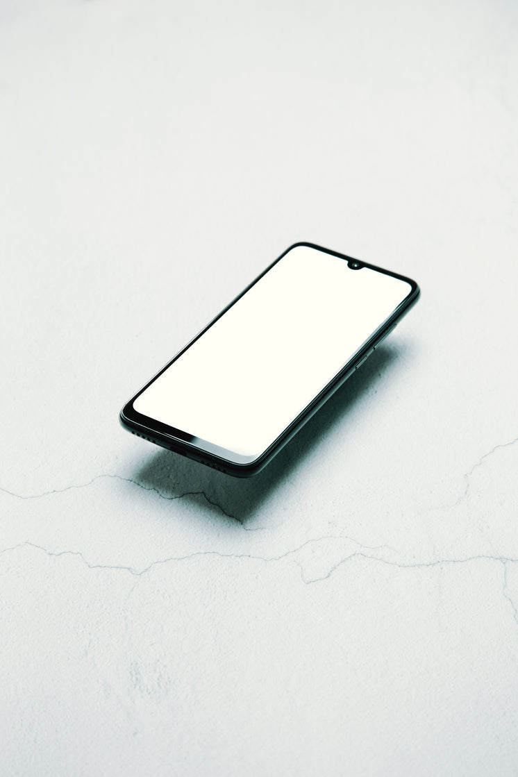 Black Cellphone Floats Over A White Surface