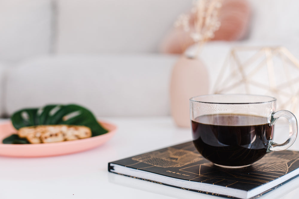 black coffee in a clear mug in a living room