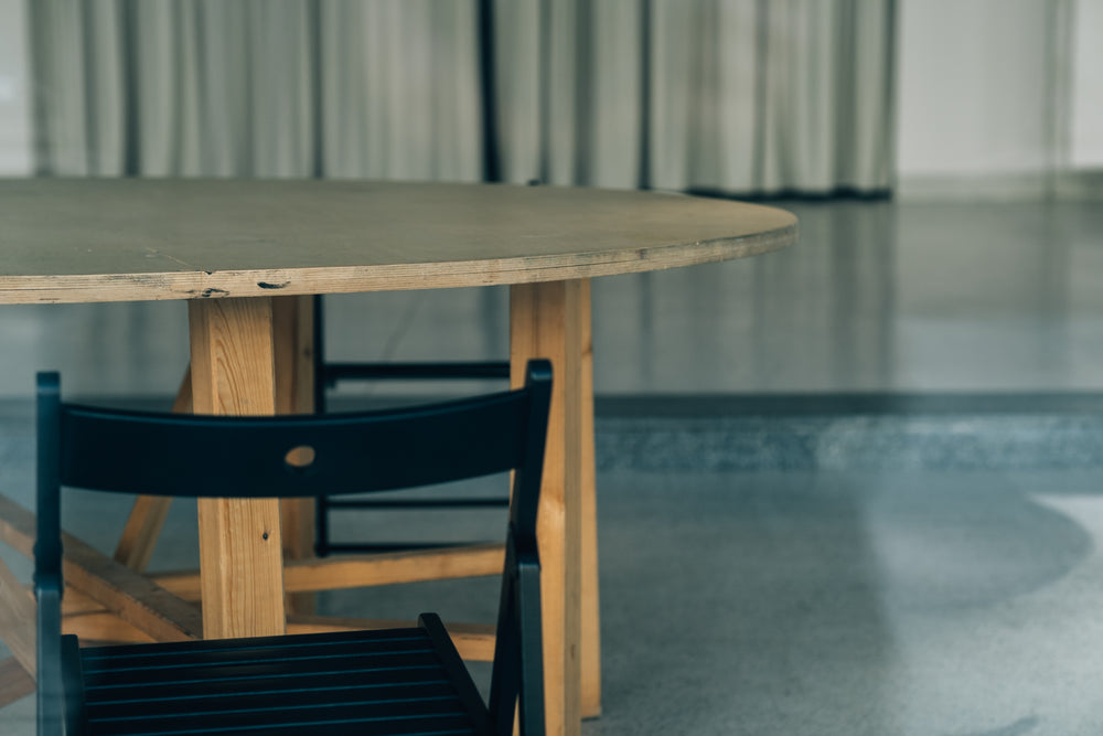 black folding chair at a wooden table