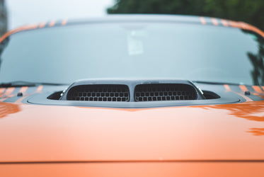 black intake on orange sportscar