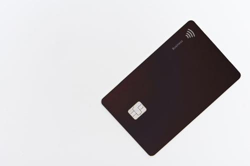 black plastic debit card on a white table