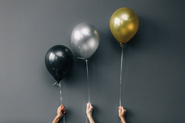 black, silver, and gold balloons