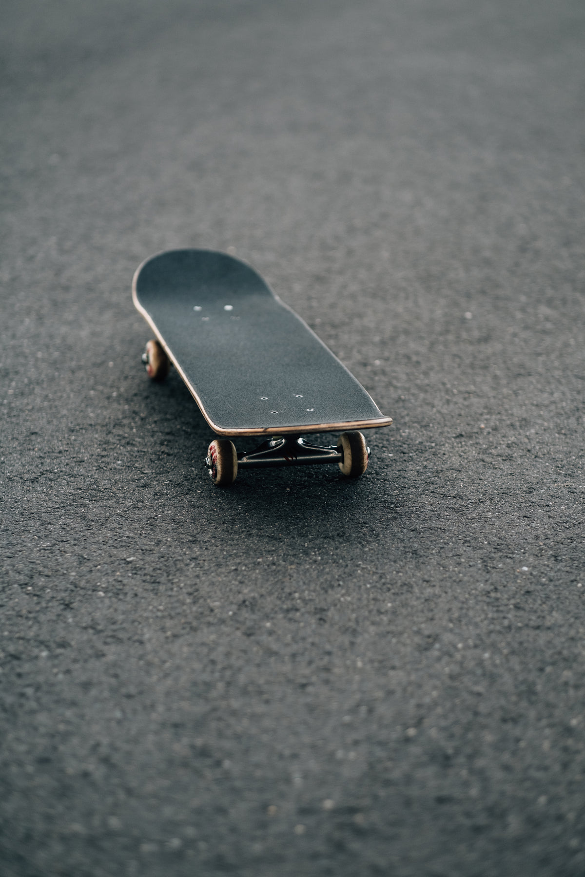 black skateboard on paved surface