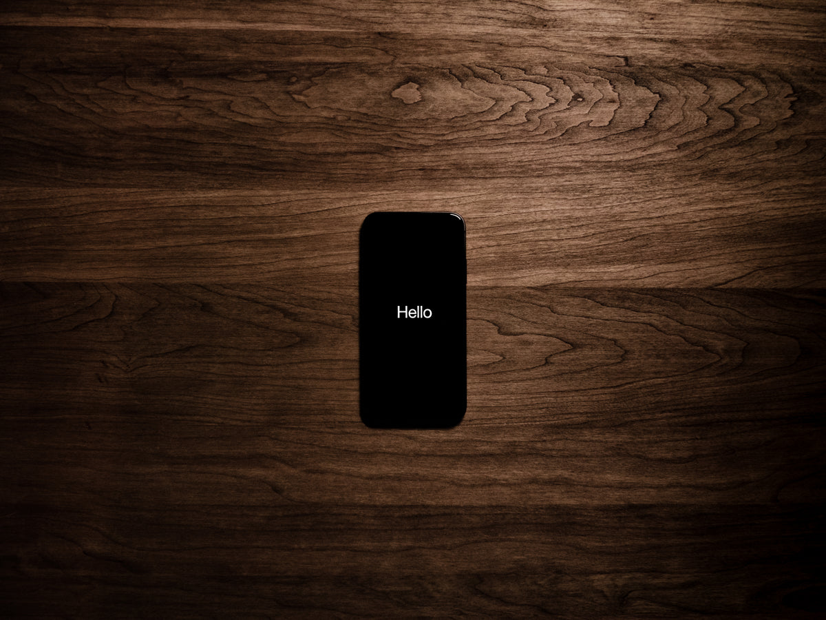 black smartphone displays the word hello