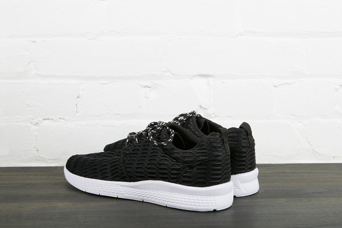 black sneakers with white sole