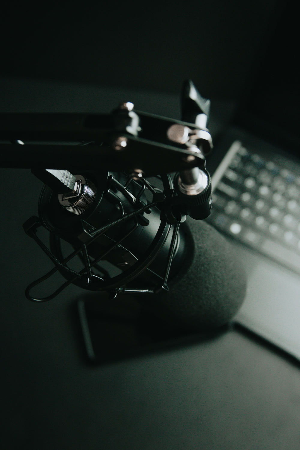 black tilted microphone and a computer keyboard