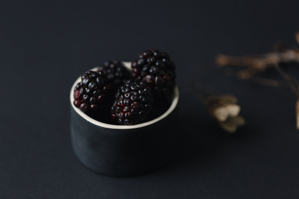 blackberries in a black dish