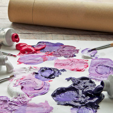 blobs of purple, red and white paint mixed together on paper