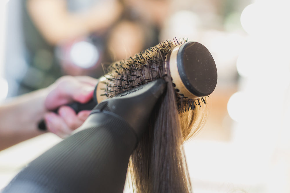 blowdrying hair on round brush