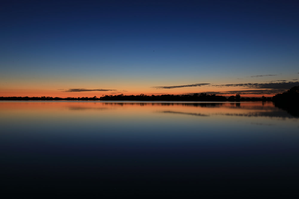 Blue And Orange Sky Over Still Water