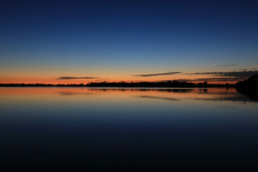 Blue And Orange Sky Over Still Water