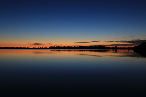 Blue And Orange Sky Over Still Water