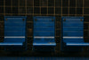 blue chairs on a subway platform