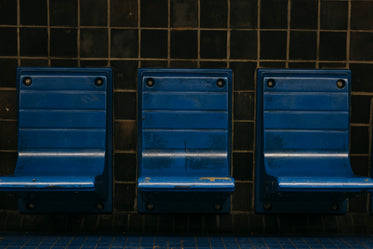 blue chairs on a subway platform