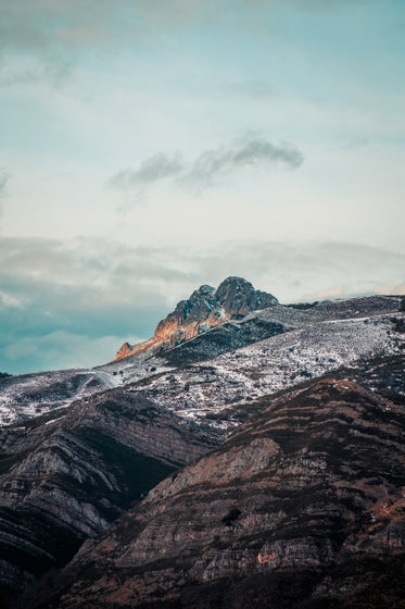 blue cloudy sky over snowy mountains