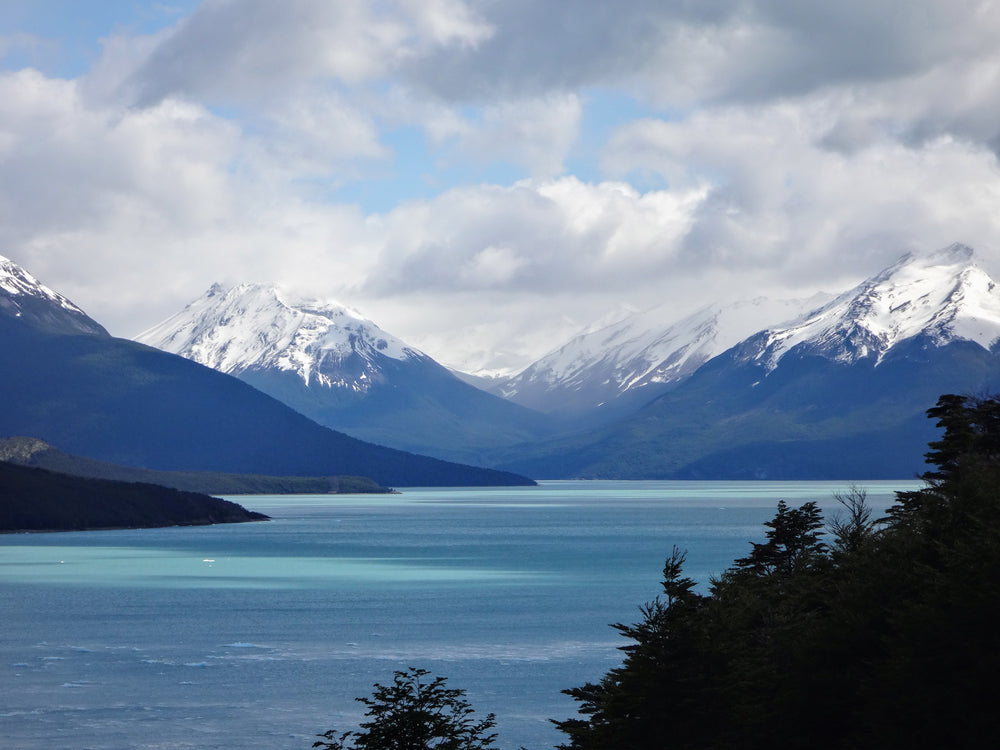 blue freshwater lake by mountain