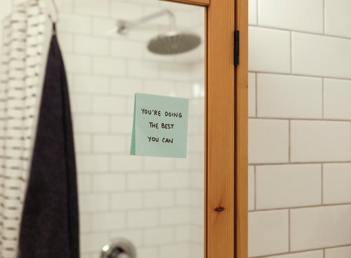 blue note on a bathroom mirror reads a positive message