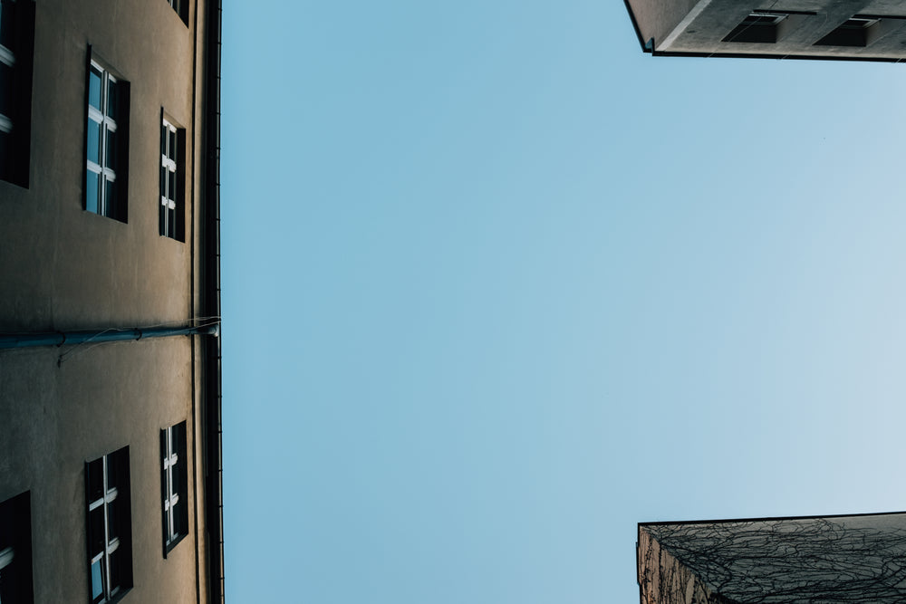 blue skies above buildings close together