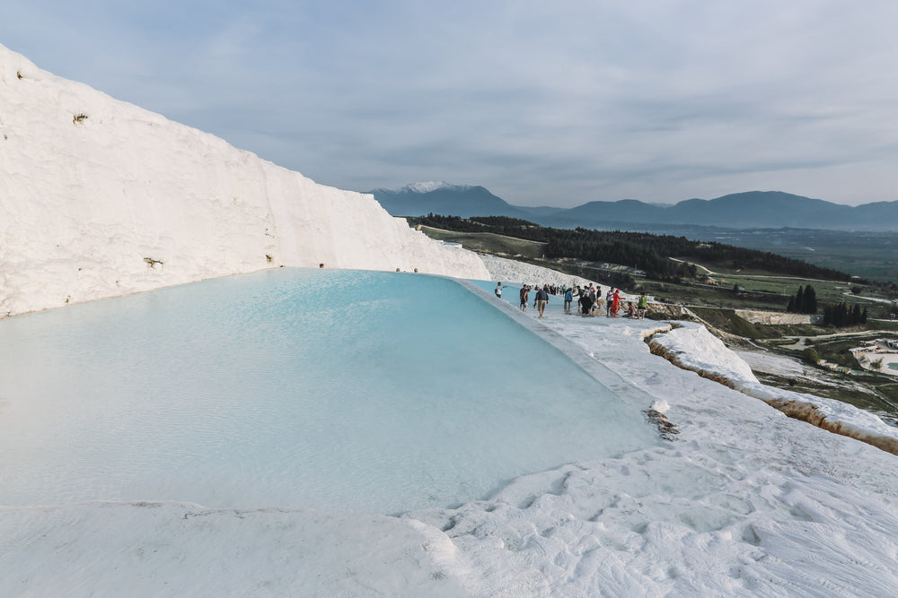 blue thermal pools contrasting countryside