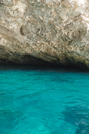 blue water and yellow rock