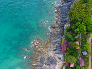 blue water reaches rocky shore