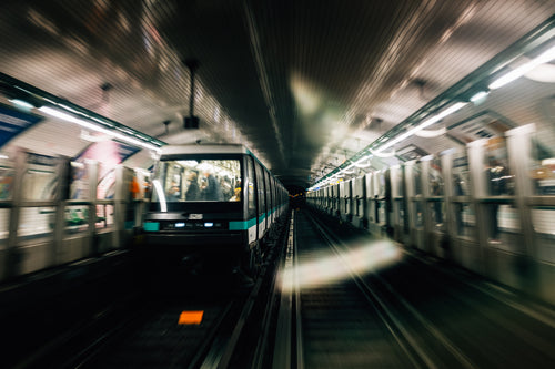 blurry photo of trains moving underground