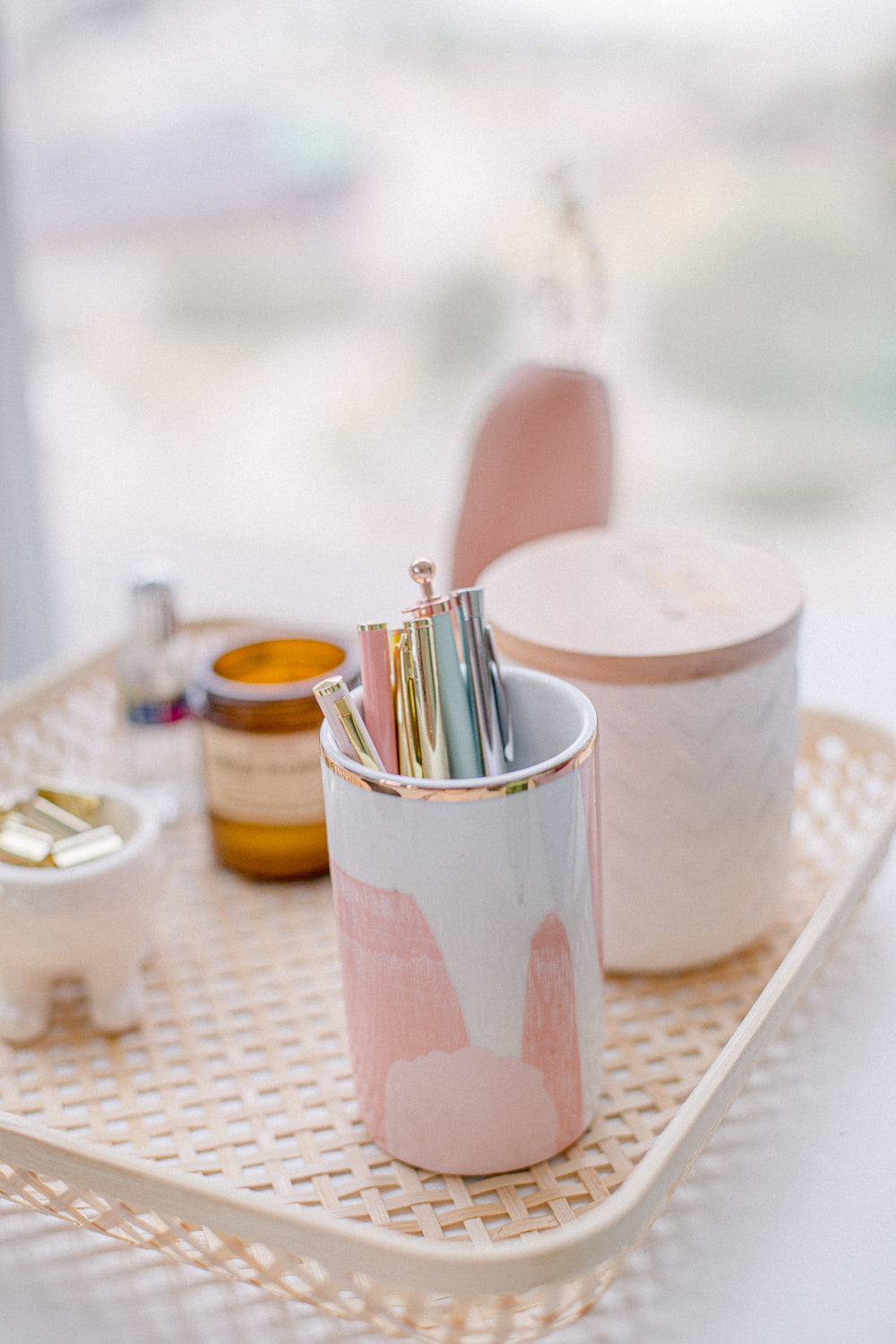 blush pink and wicker stationary organizer