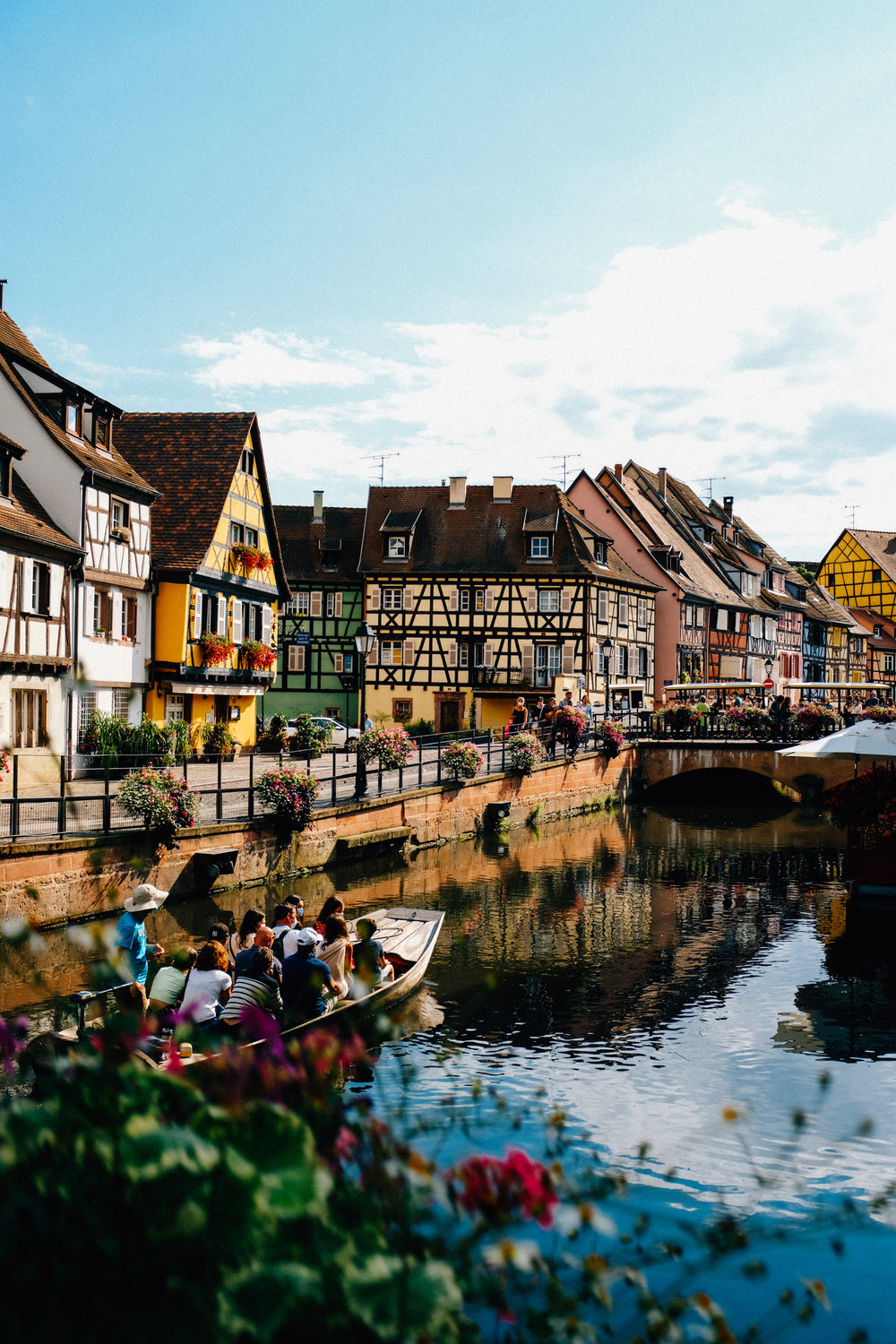 boat cruises along river overlooked by town