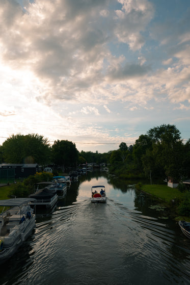 boat drives through waterway in cottage country