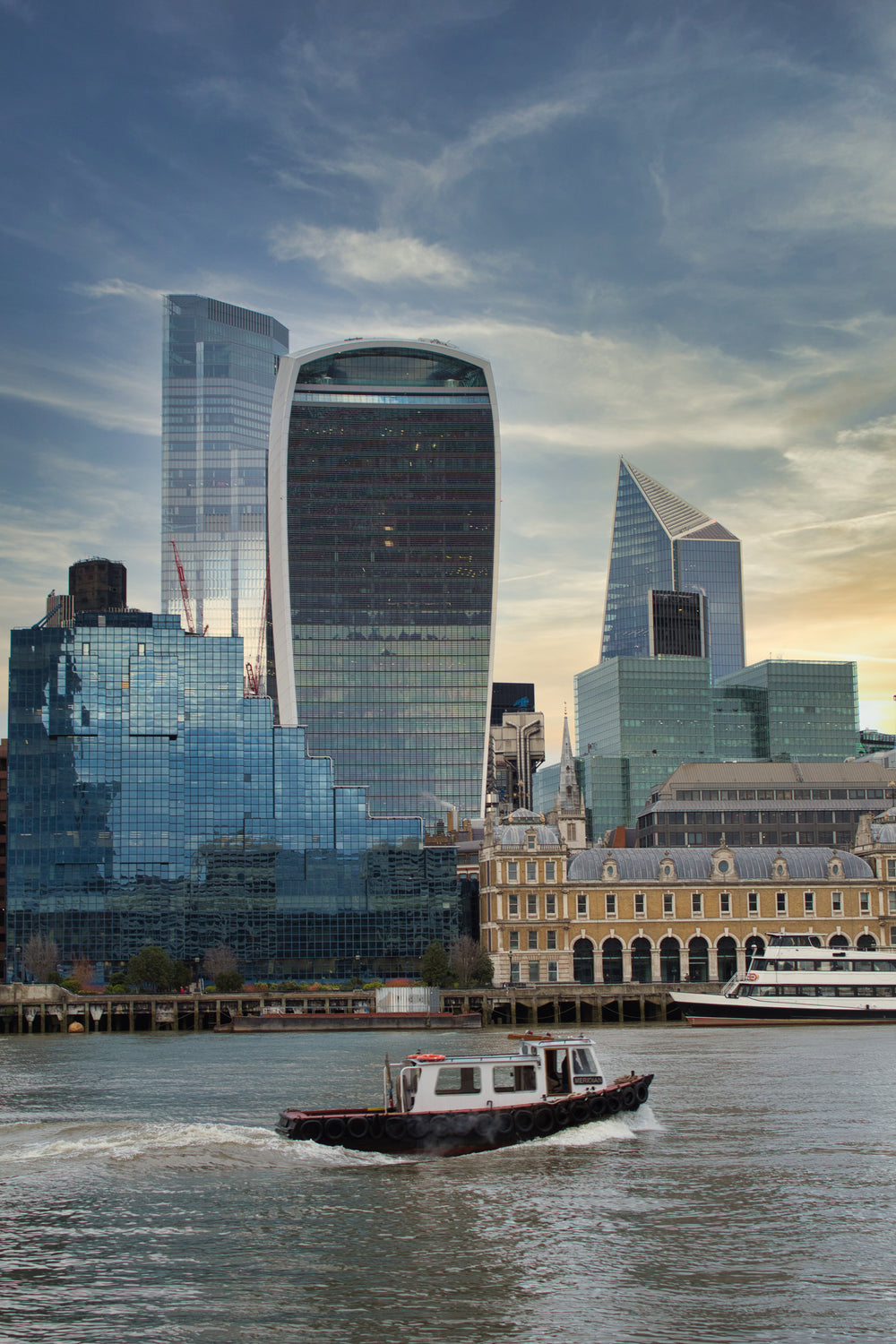 boat moving along river below walkie talkie tower