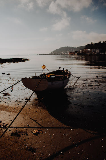 boat tethered to the shoreline at twilight