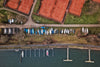 boats covered beside a dock and tennis courts