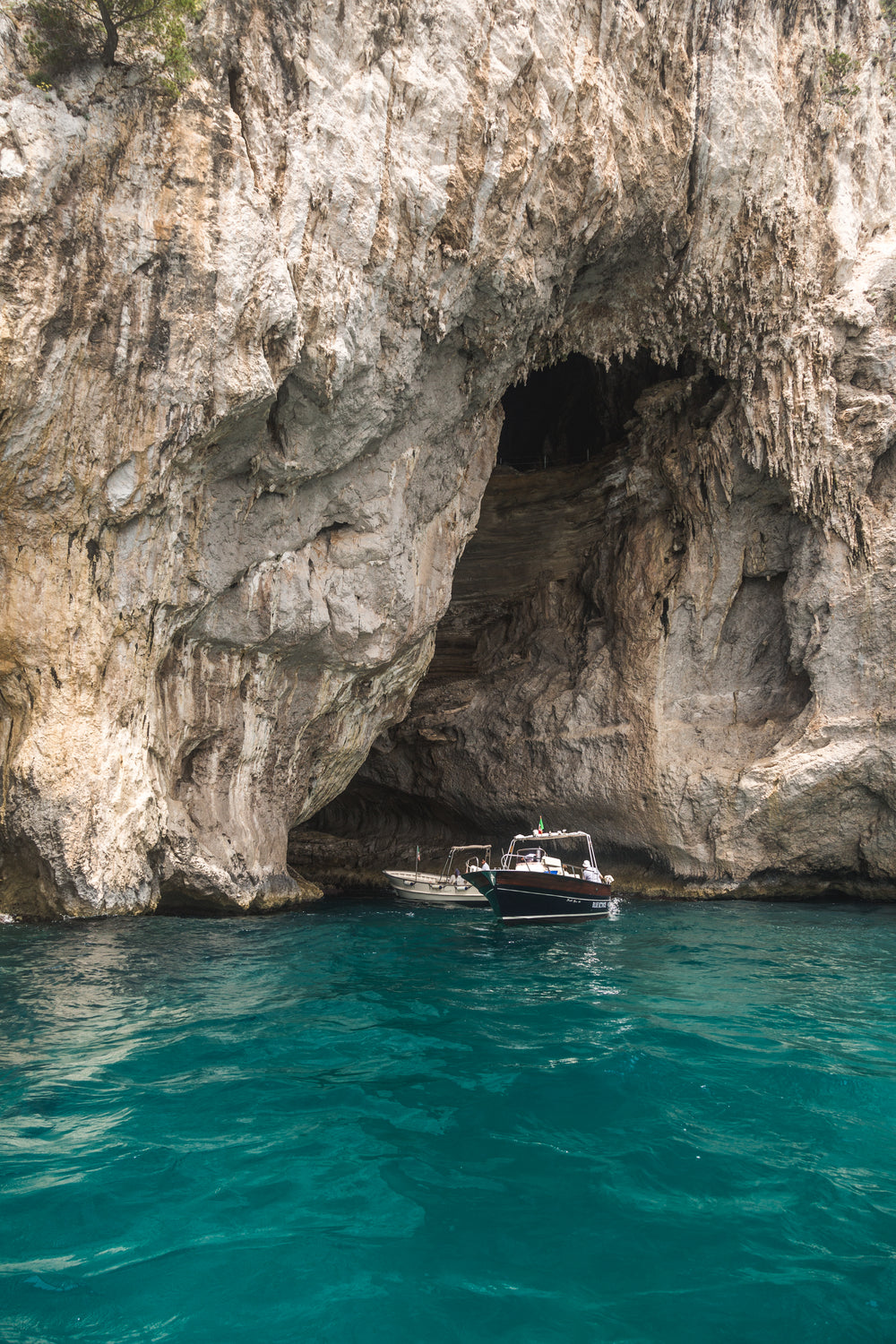 boats emerging from rocks