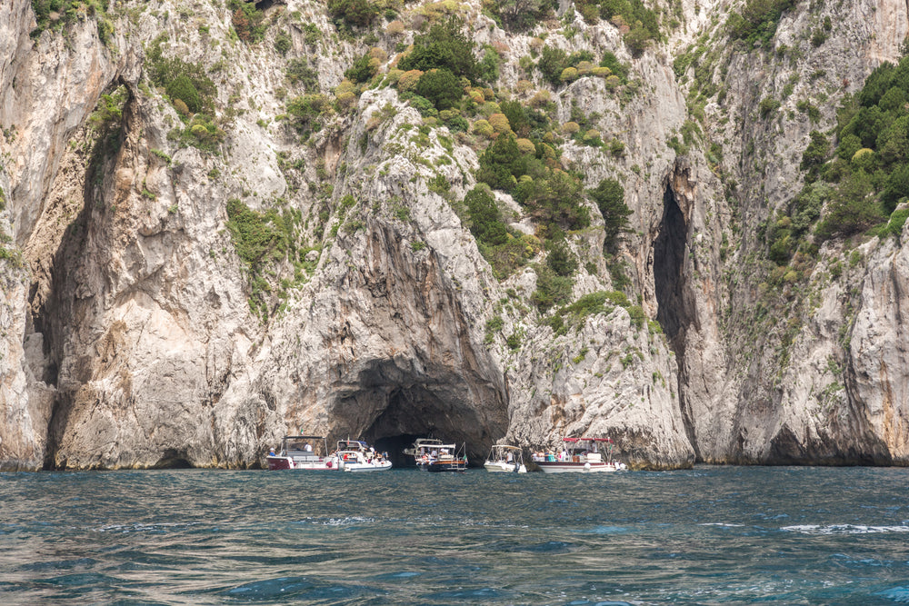 boats gathered in front of cave