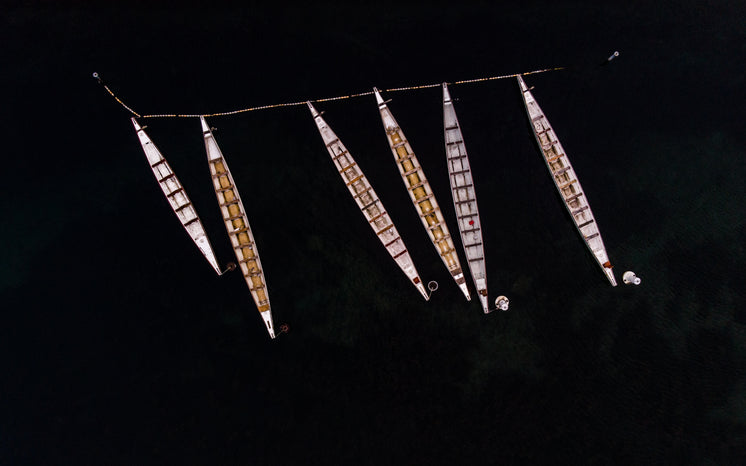 Boats Moored On Dark Water