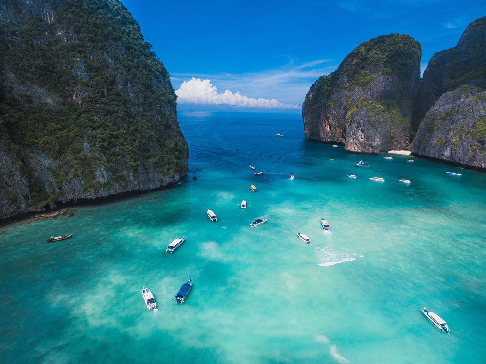 boats sail on clear blue water