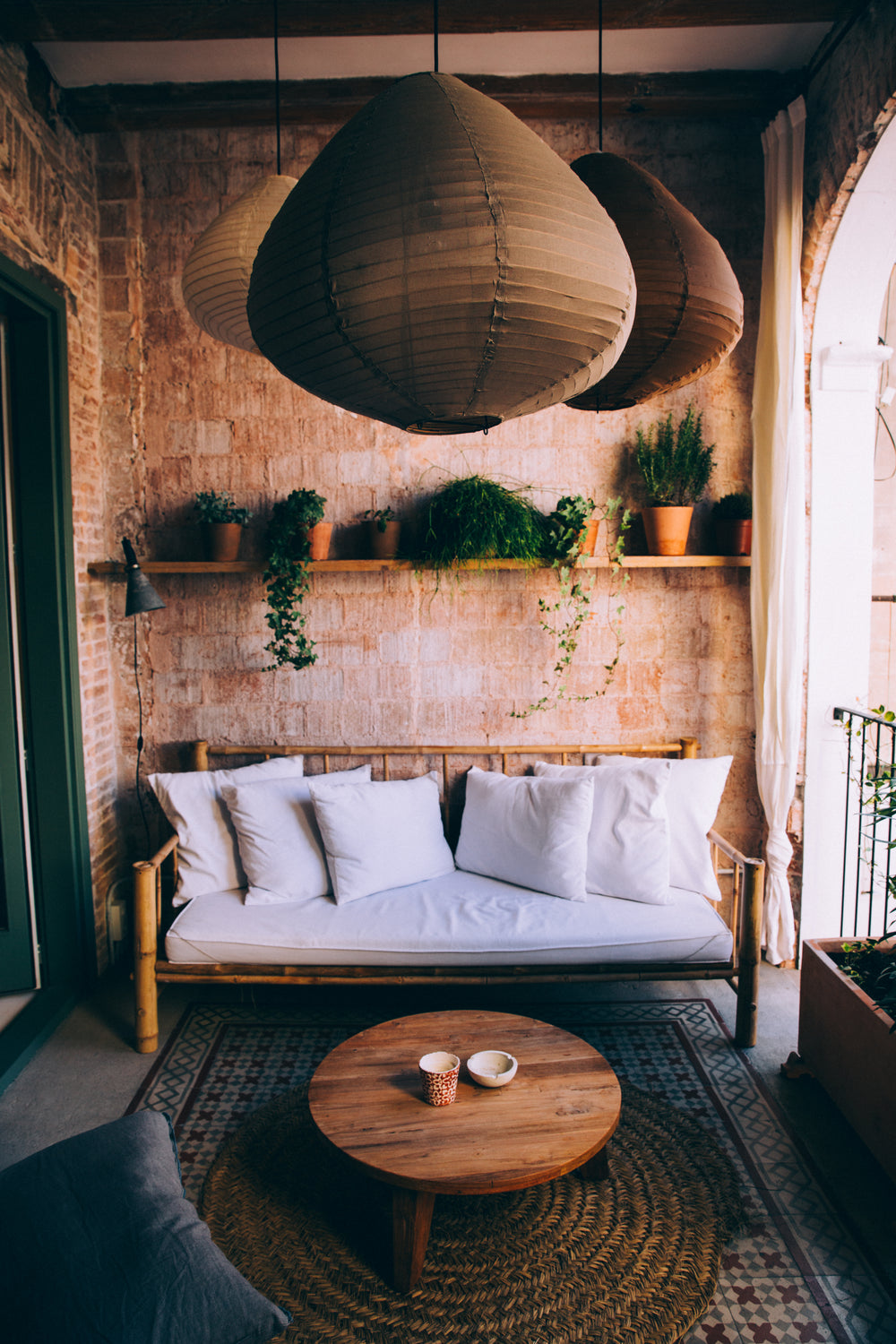 bohemian-style balcony with white bamboo sofa