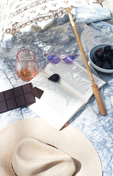 book lays open with food and drink and a summer hat