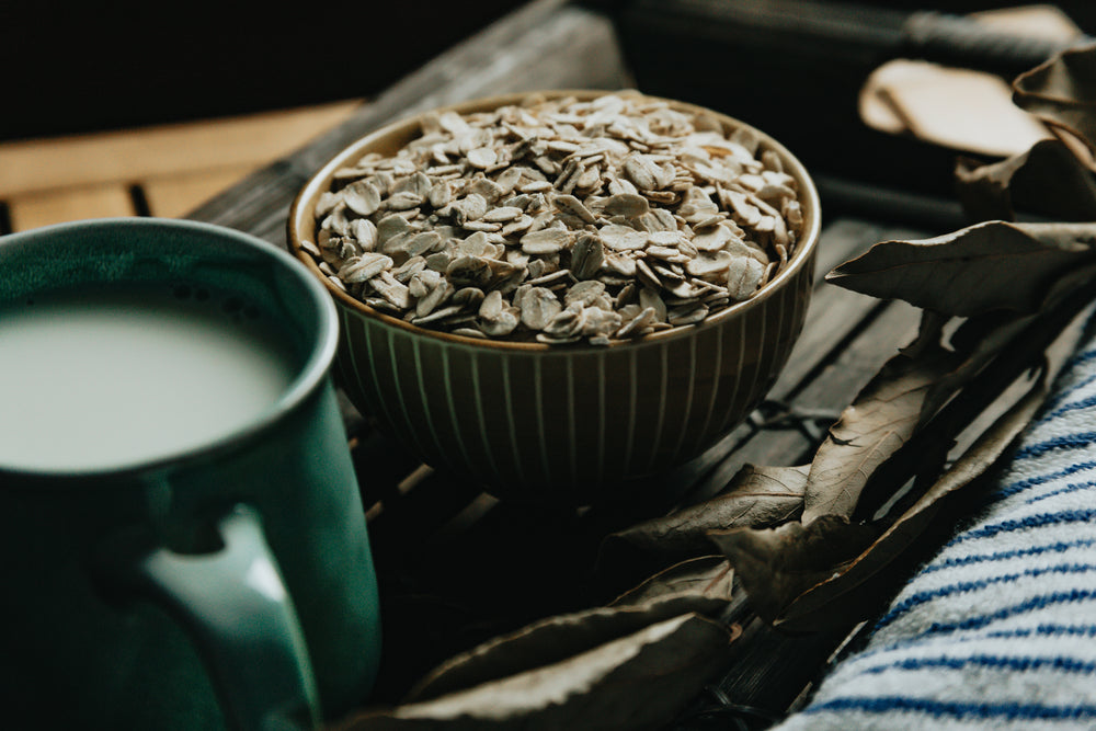 bowl of oats and a mug on a wooden tray