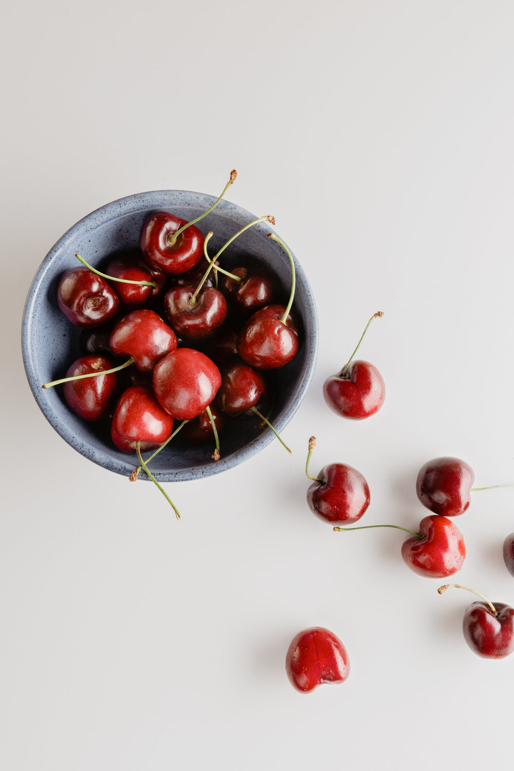 bowl of red cherries on a white background