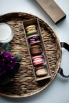 box of macarons on a wicker tray