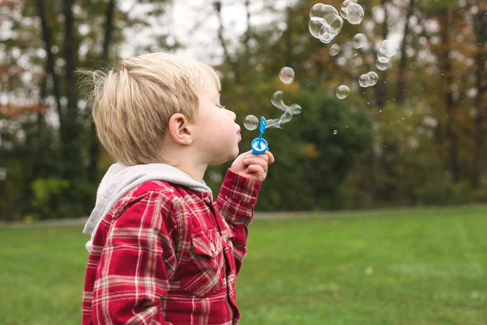 boy blowing bubbles