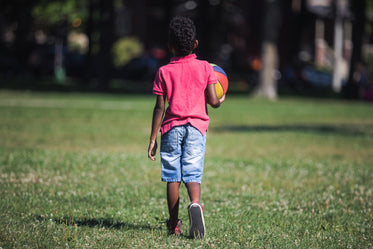 boy holds ball