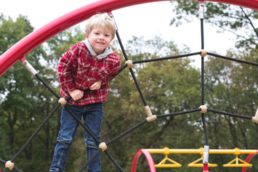 boy on climbing web